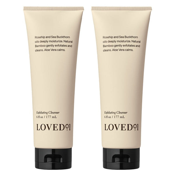 Two beige tubes of Loved 01 Deep Moisturizing Exfoliating Cleanser (6oz each), a 2-pack infused with nourishing Rosehip Oil and Sea Buckthorn Oil, both featuring black caps.